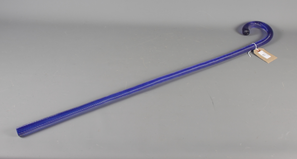 A blue spiral glass walking stick, 34" long, on oak back plate