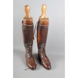 A pair of brown leather riding boots with stretchers