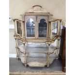 An Italian painted and gilt decorated shape front side cabinet enclosed two arch topped doors over