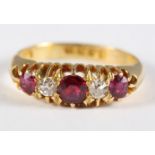 A five stone 18ct gold ring set rubies and diamonds, size M/N