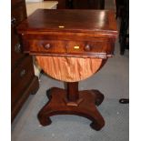 A 19th Century crossbanded mahogany work table, fitted frieze drawer and fabric well, on turned