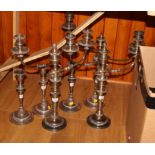 A pair of silver plate candelabra, another candelabrum and three candlesticks