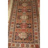 A Caucasian design rug decorated five black panels with octagonal central medallions with three
