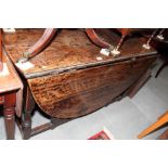 A 17th Century style oval oak drop leaf dining table, on turned underframe, 61" x 48" when fully