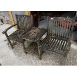 A slatted teak double garden seat with central table