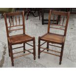A set of four Clissett dining chairs with four spindles to backs and panelled wooden seats, on