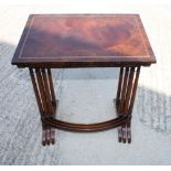 A nest of three coffee tables, polished as yew, mahogany and rosewood, on slender twin turned end