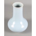 A Chinese porcelain baluster shaped vase decorated monochrome pale blue glaze with six character