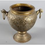 An Indian embossed brass vase, 13 1/2" high, a smaller vase with carry handle, and two North African