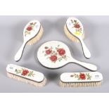 A silver guilloche enamel rose decorated five-piece vanity set