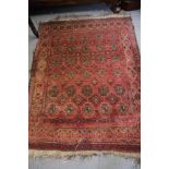 A Caucasian rug decorated six rows of octagonal guls on a red field with three border stripes, 64" x