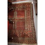 A Tekke Bokhara prayer rug decorated four panels with candlestick motifs, 55" x 48" approx