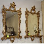 A pair of 18th Century style giltwood framed wall mirrors with flower and scroll carved frames,