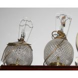 A pair of spherical glass and gilt metal table lamps decorated diamond cutting