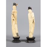 Two carved ivory figures on an ebony plinth, the taller 11" high