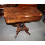 A 19th Century crossbanded rosewood fold over top tea table, on turned central column and four
