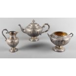 A Victorian Scottish silver three-piece teaset with embossed decoration, 41.2oz troy approx