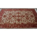 A Ziegler style rug in red and beige, 74" x 52" approx