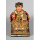 A Chinese carved wood figure of a god, with painted and gilt decoration