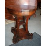 An early 19th Century style mahogany circular occasional table, on four scroll carved supports and