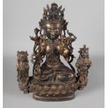 A Chinese bronze Buddha with part gilded decoration, base mounted two attendant figures, 11 1/2"