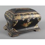 A 19th Century sarcophagus-shaped black papier mache tea caddy decorated with flowers and gilt, 8"
