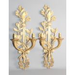 A pair of cast brass acorn design two-light wall sconces