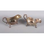 A pair of silver sauce boats with gadrooned borders, scrolled handles and three hoof feet, 16.1oz