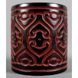 A 19th Century oriental lacquered brush pot decorated in black and burgundy, 6" high