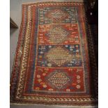 A Caucasian rug decorated four hooked lozenge medallions, on a red and blue ground with three border