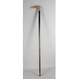 An ebonised walking cane with heron carved horn finial