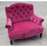 A Victorian button back armchair, upholstered in a pink velvet, on ebonised supports