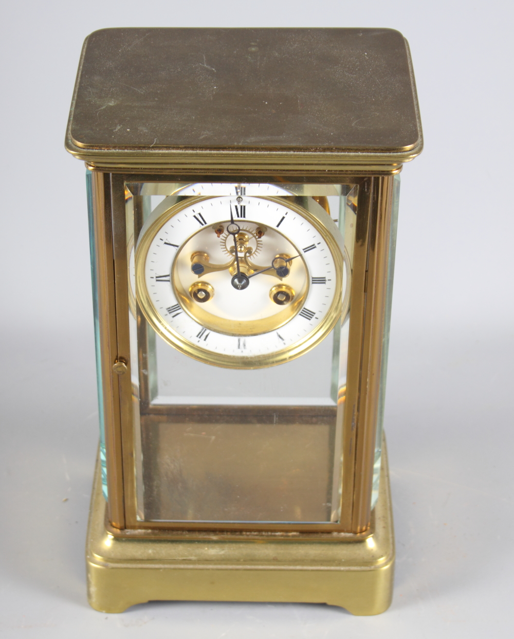 A 19th Century brass cased four-glass clock with white enamel dial and striking movement, 10 1/2"