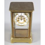 A 19th Century brass cased four-glass clock with white enamel dial and striking movement, 10 1/2"