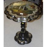 A mid Victorian ebonised tilt top occasional table with lobed papier mache top decorated mother-of-