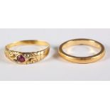 An unmarked yellow metal ruby and diamond set ring and a similar wedding band, 5.7g