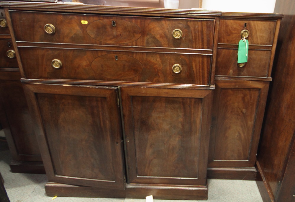 A 19th Century mahogany breakfront secretaire, fitted four drawers and cupboards, central writing