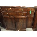 A 19th Century mahogany breakfront secretaire, fitted four drawers and cupboards, central writing