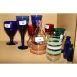 Seven wine glasses, various colours, and other glassware