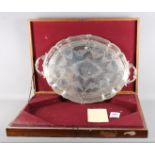 A Victorian silver serving tray with engraved decoration and armorial, cast handles, in fitted oak