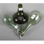 A 17th Century style green glass wine bottle with applied seal and two green glass flasks