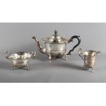 A silver three-piece teaset, the teapot with ebonised knop and handle, 27.8oz troy appox