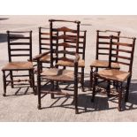 A set of five 19th Century rush seat ladder back dining chairs with decorative turned top rails (one