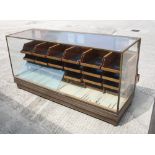 A brass framed shop display counter, fitted twenty-four drawers, 72" wide (ex Jackson's Corner Shop