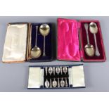 Three sets of silver spoons, in cases