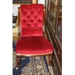 A Victorian mahogany framed nursing chair with buttoned back and overstuffed seat, upholstered in