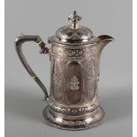A Victorian Scottish silver hot water jug with cast and engraved decoration in the gothic manner,
