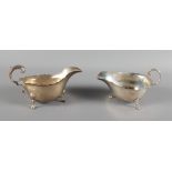 A silver sauce boat with scrolled handle and another smaller similar, 8.2oz troy approx