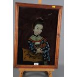 A late 19th Century Chinese reverse painted glass picture of a young girl with dog, 19" x 13", in