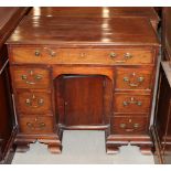 A George III mahogany desk, fitted seven drawers and recessed cupboard to kneehole